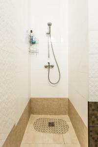 a bathroom with a shower with a tile floor at Gagarin Plaza apartment 70 square metres on 12th floor in Odesa +13 photos