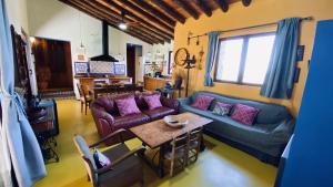 a living room with a couch and a table at Casa Rural Sierra de Aguafría. Finca El Robledillo in Monesterio