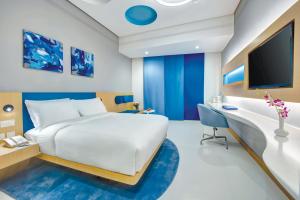 a bedroom with a bed and a desk and a tv at Al Khoory Inn Bur Dubai in Dubai