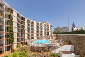 an apartment building with a swimming pool in front of it at SeaBliss Beach of Dunes, Terrace and Pool! in San Bartolomé