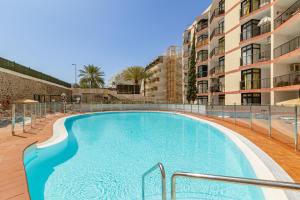 a swimming pool in front of a building at SeaBliss Beach of Dunes, Terrace and Pool! in San Bartolomé