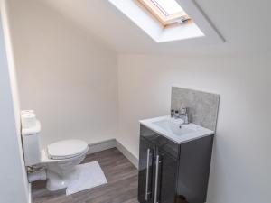 a bathroom with a white toilet and a sink at Pass the Keys Beautiful flat near Nottingham city with parking in Nottingham