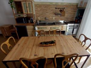 a wooden table in a kitchen with a pizza on it at Cuore di Mandorla in Conversano