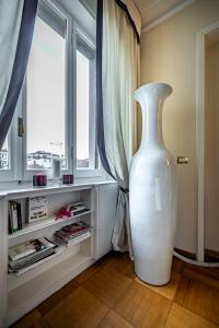 a large white vase sitting in front of a window at YID D'Azeglio luxury apartment in Florence