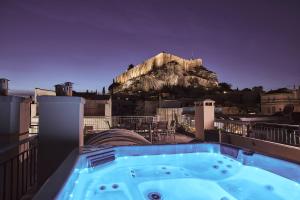 a hot tub on a balcony with a mountain at Plaka's Villa with Breathtaking Acropolis view in Athens