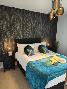 een slaapkamer met een groot bed en een blauwe deken bij Boutique Abode - With Hot Tub in Chester