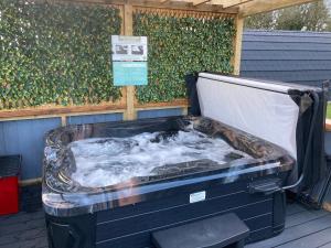 a hot tub sitting on top of a deck at Coolaness Glamping in Irvinestown