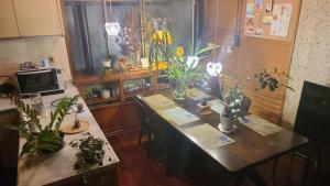 a room with a table with potted plants on it at Haruka 紫 in Naha