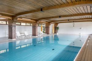 a swimming pool with blue tiles in a building at Appartment 160, 80qm in Obertal