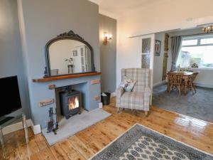 a living room with a fireplace and a tv at Fellend House in Bishop Auckland