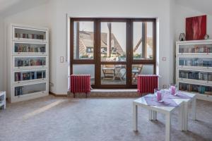 a living room with two tables and a large window at Dreiländereck in Hartheim