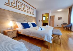 a bedroom with a large bed with blue pillows at Plitvice Lower Lakes Rooms in Plitvička Jezera