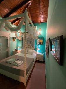 a bedroom with a canopy bed in a room at Saronic Seafront in Salamís