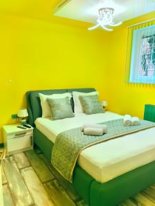 a bedroom with two beds with yellow walls at Sofiel cozy apartment - Top Center Sofia in Sofia