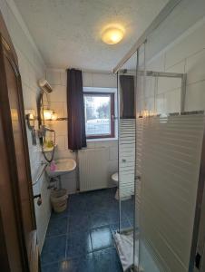 a bathroom with a shower and a toilet and a sink at Hotel Eiserner Anton in Bielefeld +142 photos