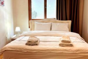 a bedroom with a bed with two towels on it at A large, comfortable flat in the best area of Ankara, Turkey in Ankara