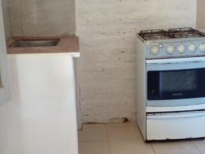 a kitchen with a white stove and a sink at Depto muy confortable in Corrientes