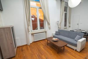 a living room with a couch and a table at Solmi Home in Modena