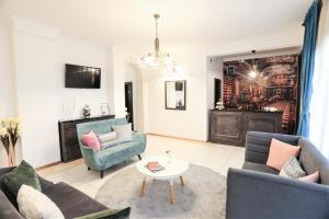 a living room with two couches and a table at Boutique Hotel Kredo in Herceg-Novi