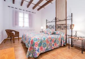 a bedroom with a bed and a chair and a table at Apartamentos & Bungalows Ubiarco El Acebo by Alterhome in Ubiarco