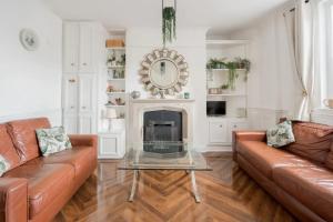 a living room with a couch and a fireplace at Unique & Central 3BD - Dublin City in Dublin