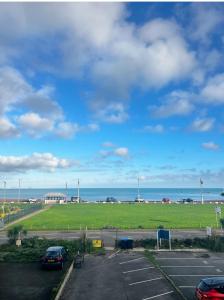 a parking lot with a view of the ocean at The Commodore Rooms & Relaxation in Paignton