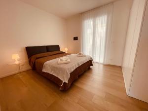 a bedroom with a bed with two towels on it at APP4RENT GROUND FLOOR - 2 family apartments in Lido di Jesolo +38 photos