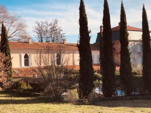 a group of trees in front of a building at Une chapelle en soie in Taulignan