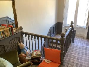 a room with a staircase with a stuffed animal and a chair at Brookfield House Warcop in Warcop