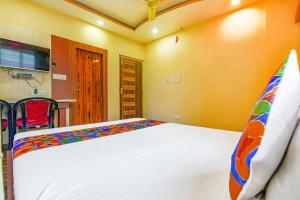 a bedroom with a large white bed in a room at FabHotel AG Star - Nr Kolkata Airport in kolkata