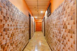 an empty hallway with brick walls and a door at FabHotel AG Star in kolkata