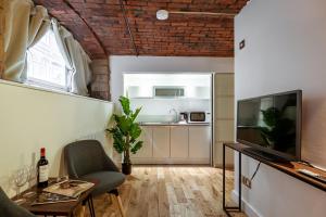 a small living room with a television and a table at Mandega House in Sheffield