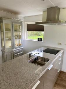 a kitchen with a sink and a counter top at Ballumerhoeve t Pandje in Ballum