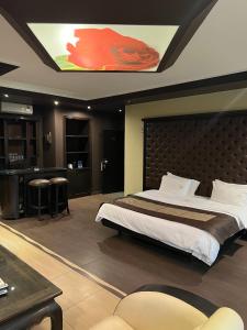 a bedroom with a large bed and a kitchen at Dolls Hotel By Eurostars in Jounieh