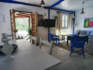 a living room with a table and blue chairs at La Casita by Teresa in Marbella