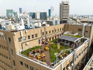 a rooftop garden on the roof of a building at Abraham Tel Aviv in Tel Aviv