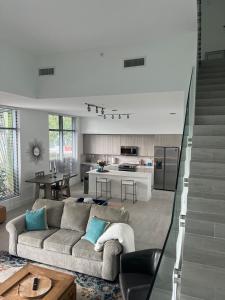 a living room with a couch and a kitchen at 3 Story Luxury Apt Las Olas FTL in Fort Lauderdale