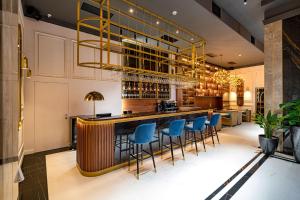 a bar in a restaurant with blue bar stools at PRESTIGE PLAZA in Suceava