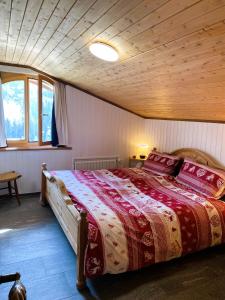 a bedroom with a large bed with a wooden ceiling at Apartment Margherita in Sedrun