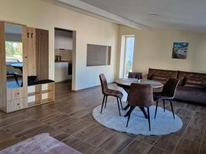 a living room with a table and chairs and a couch at Alvydo apartamentai in Kaunas
