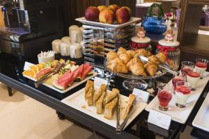 a buffet with various types of food on a table at Hotel DeSilva Premium Poznań in Poznań