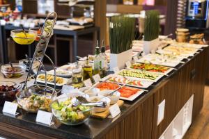 a buffet line with many different types of food at Hotel DeSilva Premium Poznań in Poznań
