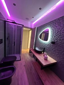 a bathroom with two toilets and a sink and a mirror at La balena bianca house in Bagni San Filippo +31 photos