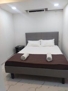 a bedroom with a bed with two towels on it at Seapoint(Seascape) in Dapoli