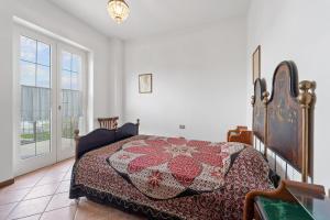a bedroom with a bed with a quilt on it at Casa del vento 2 in Tratalias