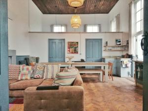 a living room with a couch and a table at Ty Capel Vestry in Conwy