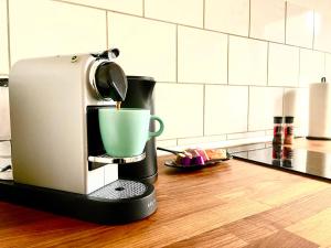 オーバーハウゼンにあるZuhause im Ruhrgebietのコーヒーメーカー(カウンター内、緑のカップ付)