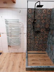 a shower with a glass door in a bathroom at SQUARE 16 - Absolutely Central Location in Szombathely
