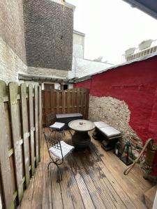 a patio with a table and chairs on a wooden deck at Deutzer Traumappartment in Cologne