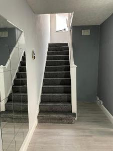 a staircase in a house with a stair case at 2 Bedroom Ground Floor Holiday Apartment Skegness in Lincolnshire